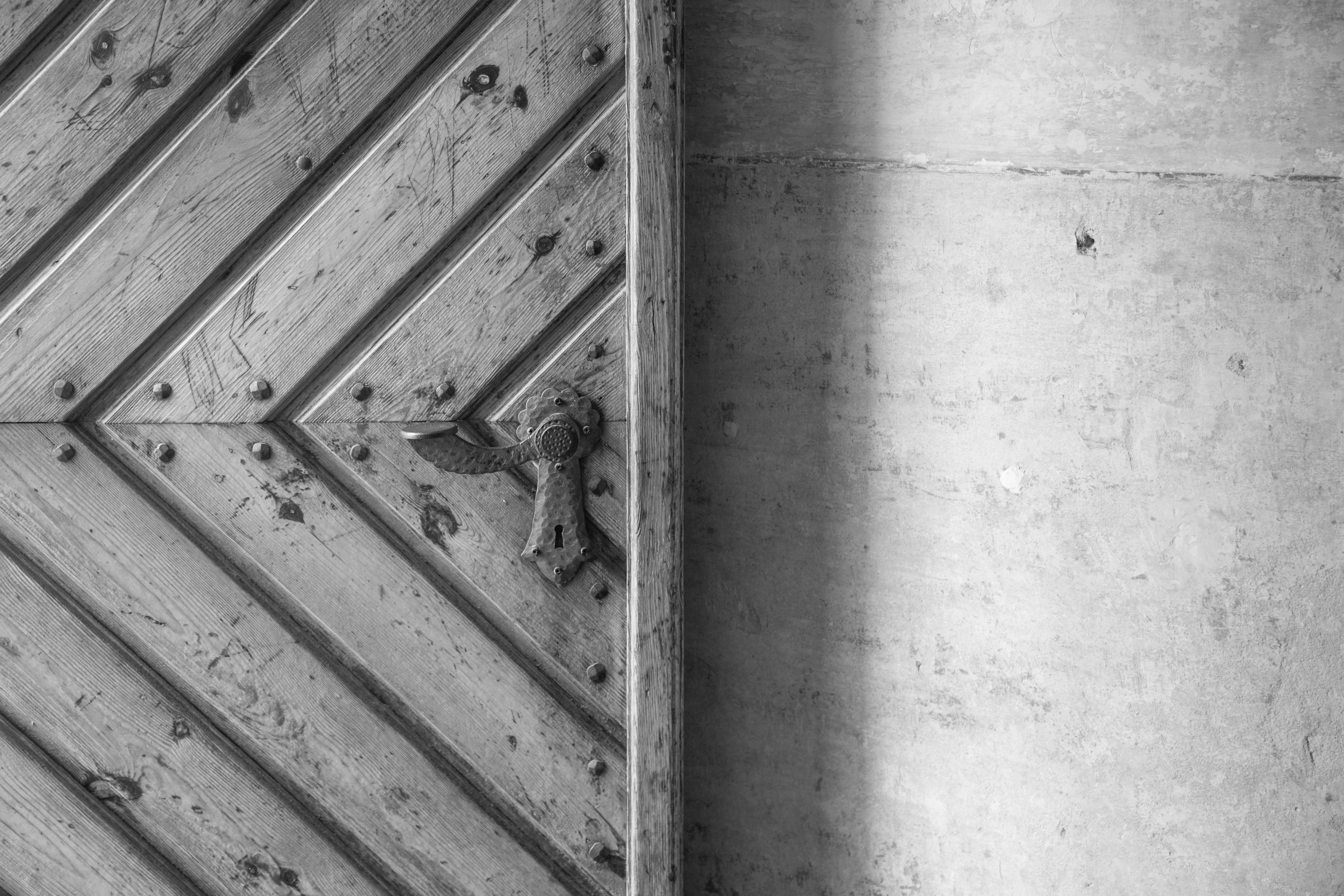 grayscale photo of wooden door